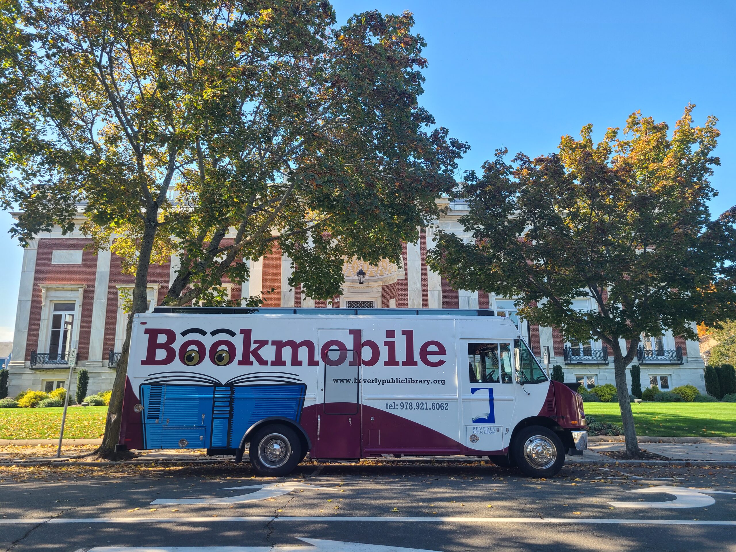Beverly Bookmobile parked by trees.