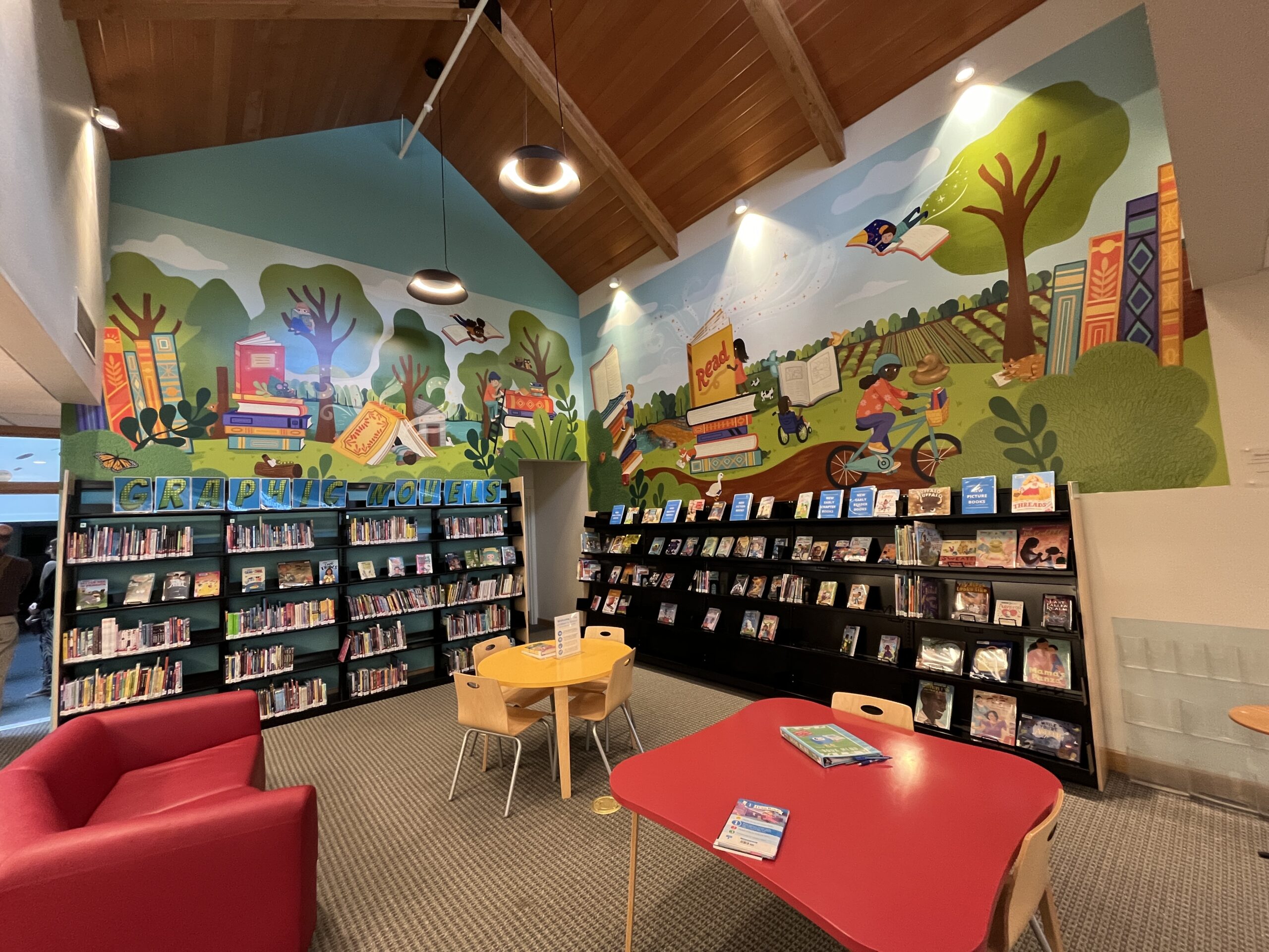 A mural and books in the children's section of the Concord Free Public Library.