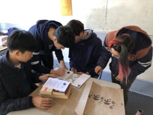 Students gathered at a table at Books through Bars