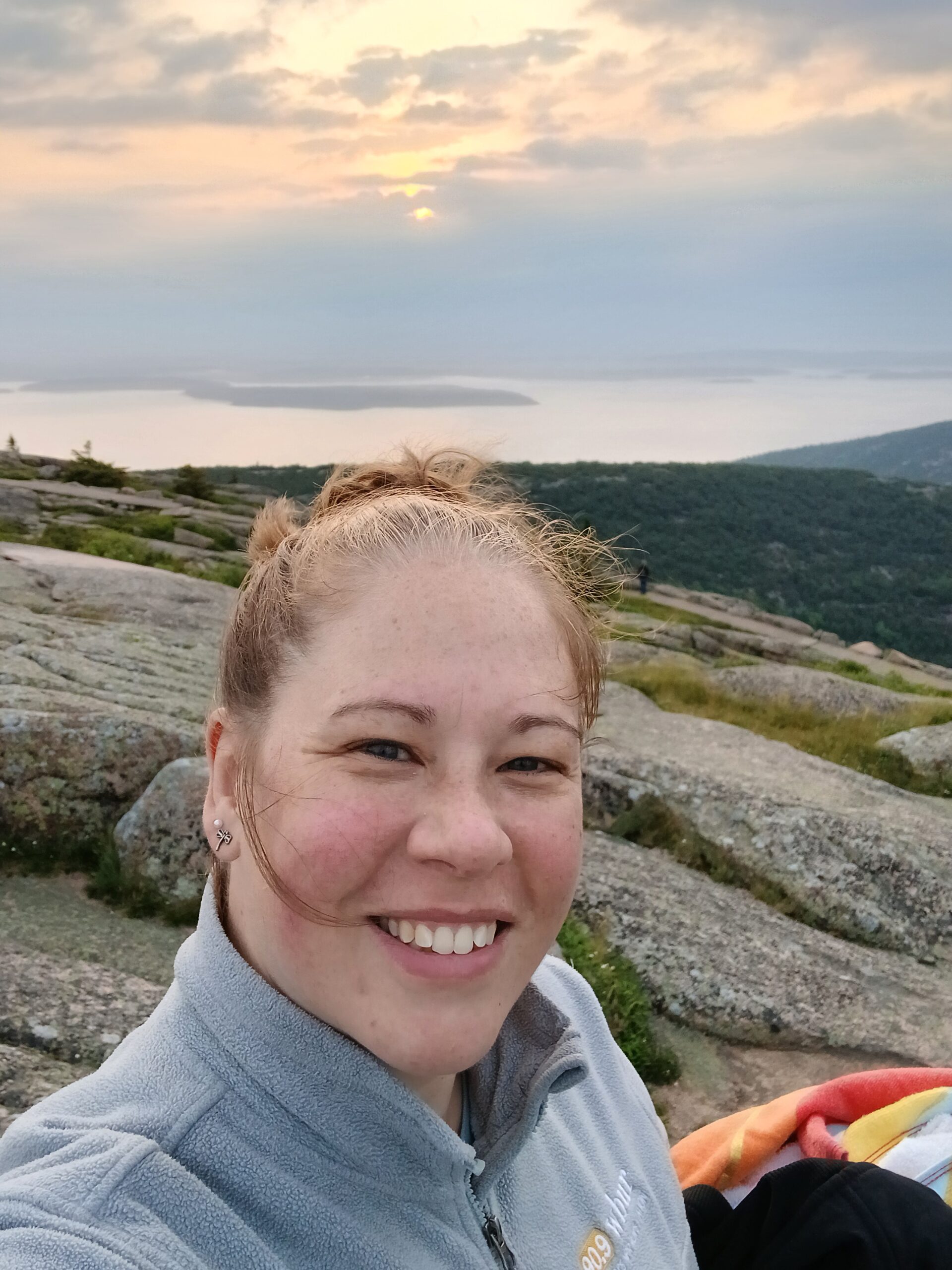 Martha Meacham smiling in front of a scenic view.