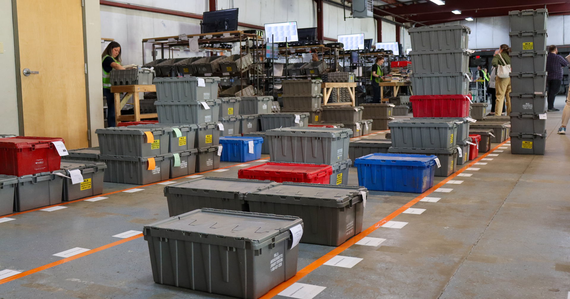 Rows of closed sorting bins organized on the floor.