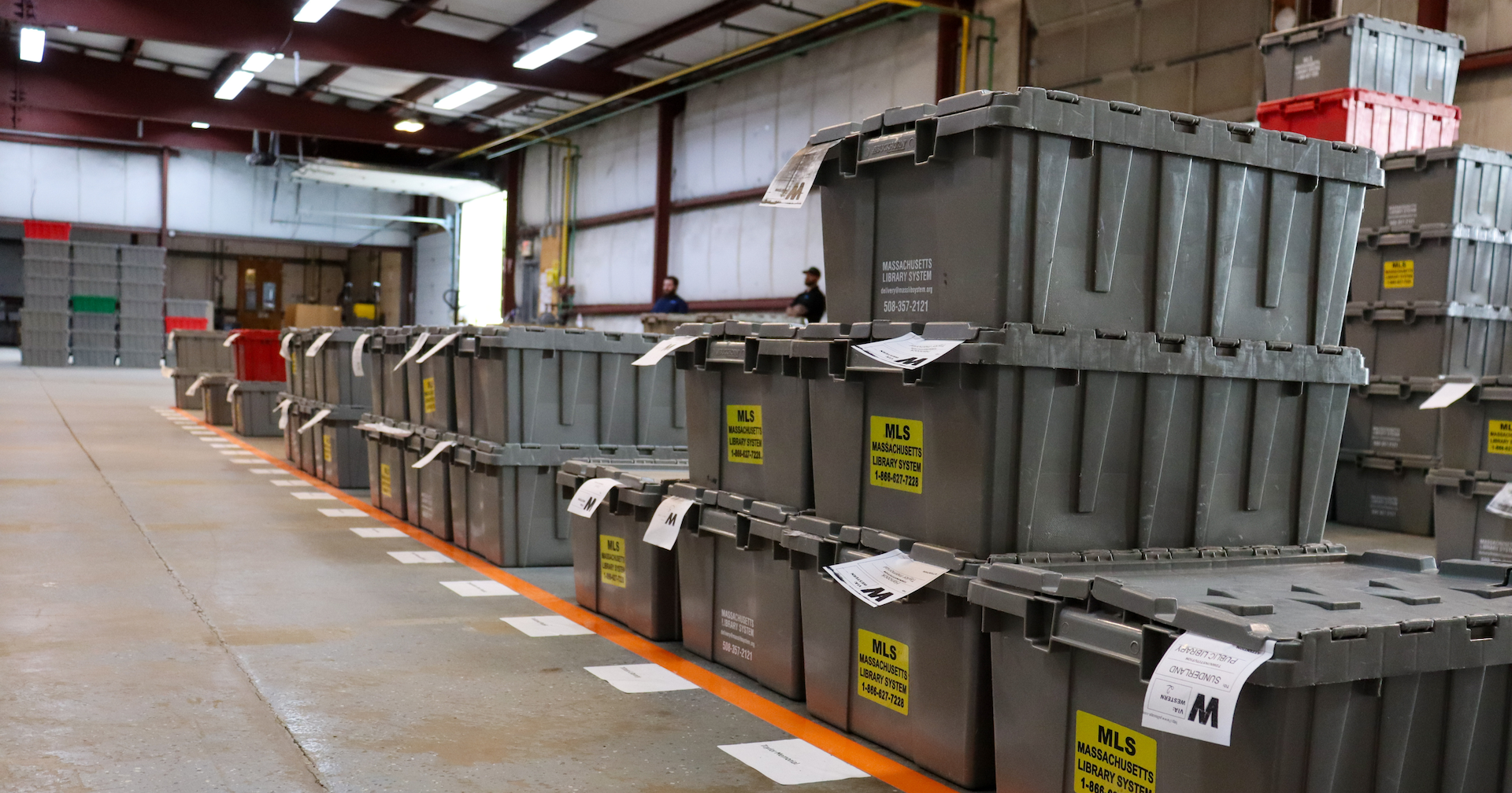 Rows of closed sorting bins organized on the floor with slips sticking out.