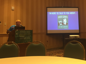 librarian, Rob Lorino, at a podium with presentation slide featured behind him